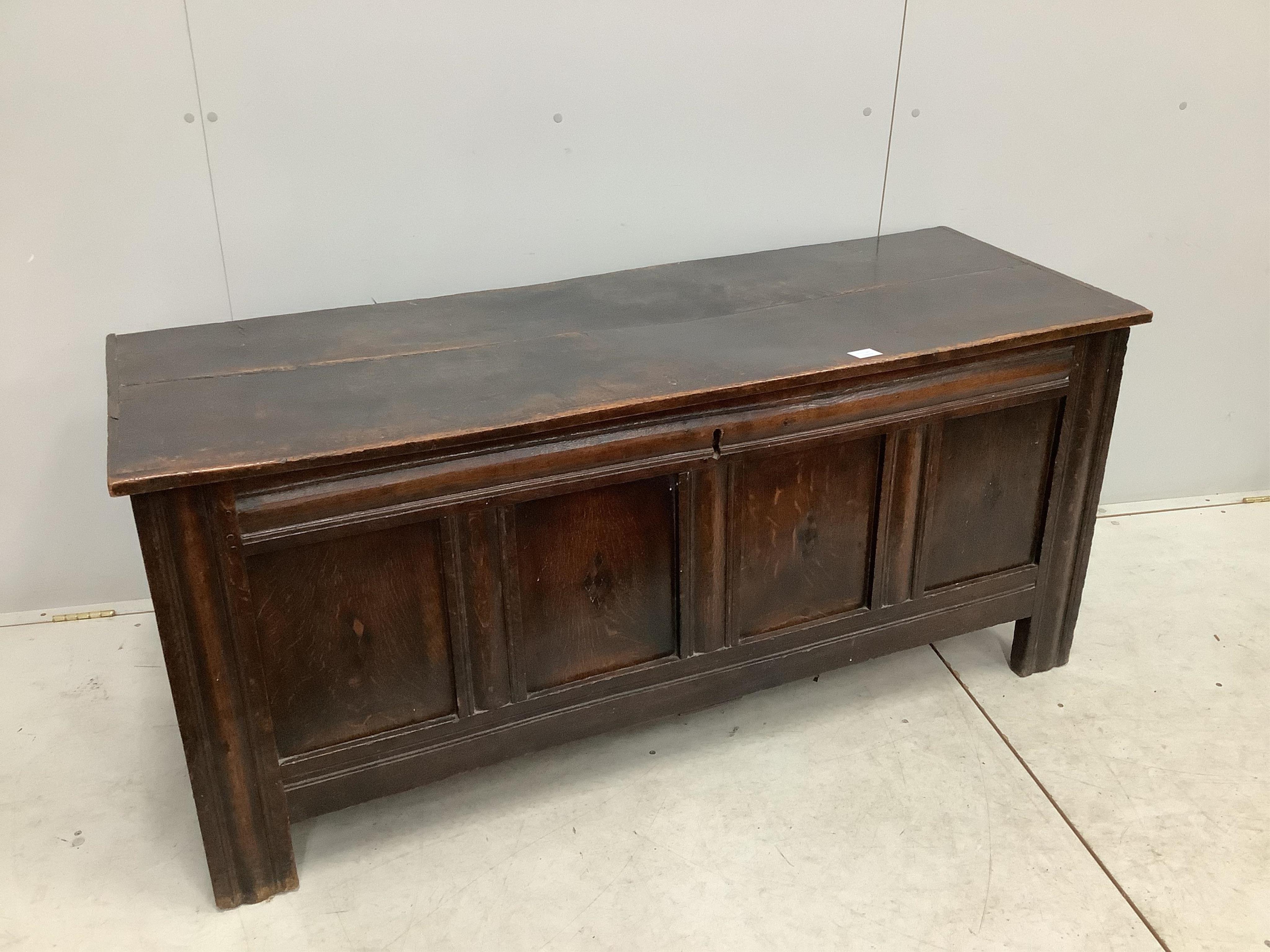 An early 18th century panelled oak coffer, width 151cm, depth 54cm, height 66cm. Condition - poor to fair